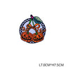 Iron-on patch featuring an embroidered orange pumpkin with a green stem and bow on a black and white background
