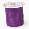 A spool of purple multicolor elastic beading cord with a decorative label on top.