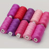 A collection of vibrant colored polyester sewing thread spools arranged diagonally.
