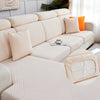 A beige jacquard plush sofa cushion cover with striped fabric and accent pillows on a light-colored sofa.