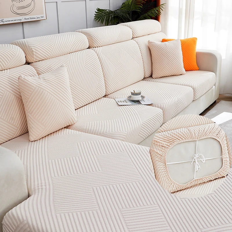 A beige jacquard plush sofa cushion cover with striped fabric and accent pillows on a light-colored sofa.