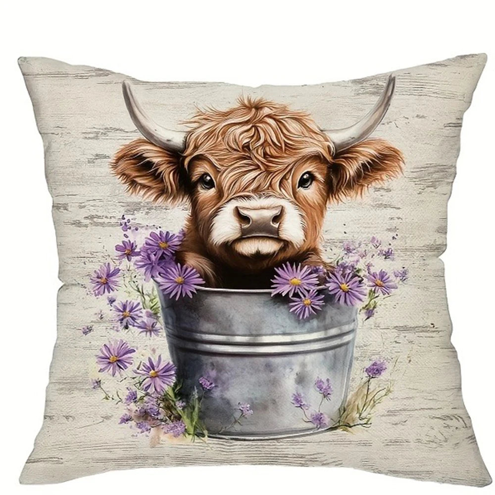 A decorative pillow cover featuring a print of a brown Highland cow with horns surrounded by purple flowers.