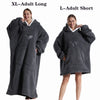 A woman models a dark gray XL adult long fleece blanket hoodie and an L adult short fleece blanket hoodie.