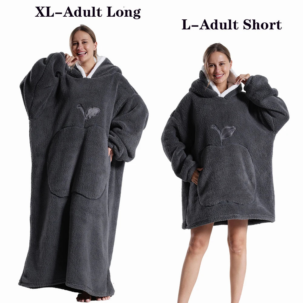 A woman models a dark gray XL adult long fleece blanket hoodie and an L adult short fleece blanket hoodie.