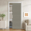 A vertical magnetic accordion pleated door curtain in gray and white stripes installed in a white door frame.