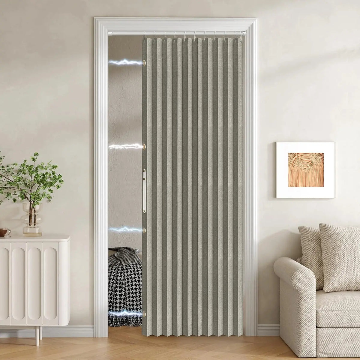 A vertical magnetic accordion pleated door curtain in gray and white stripes installed in a white door frame.