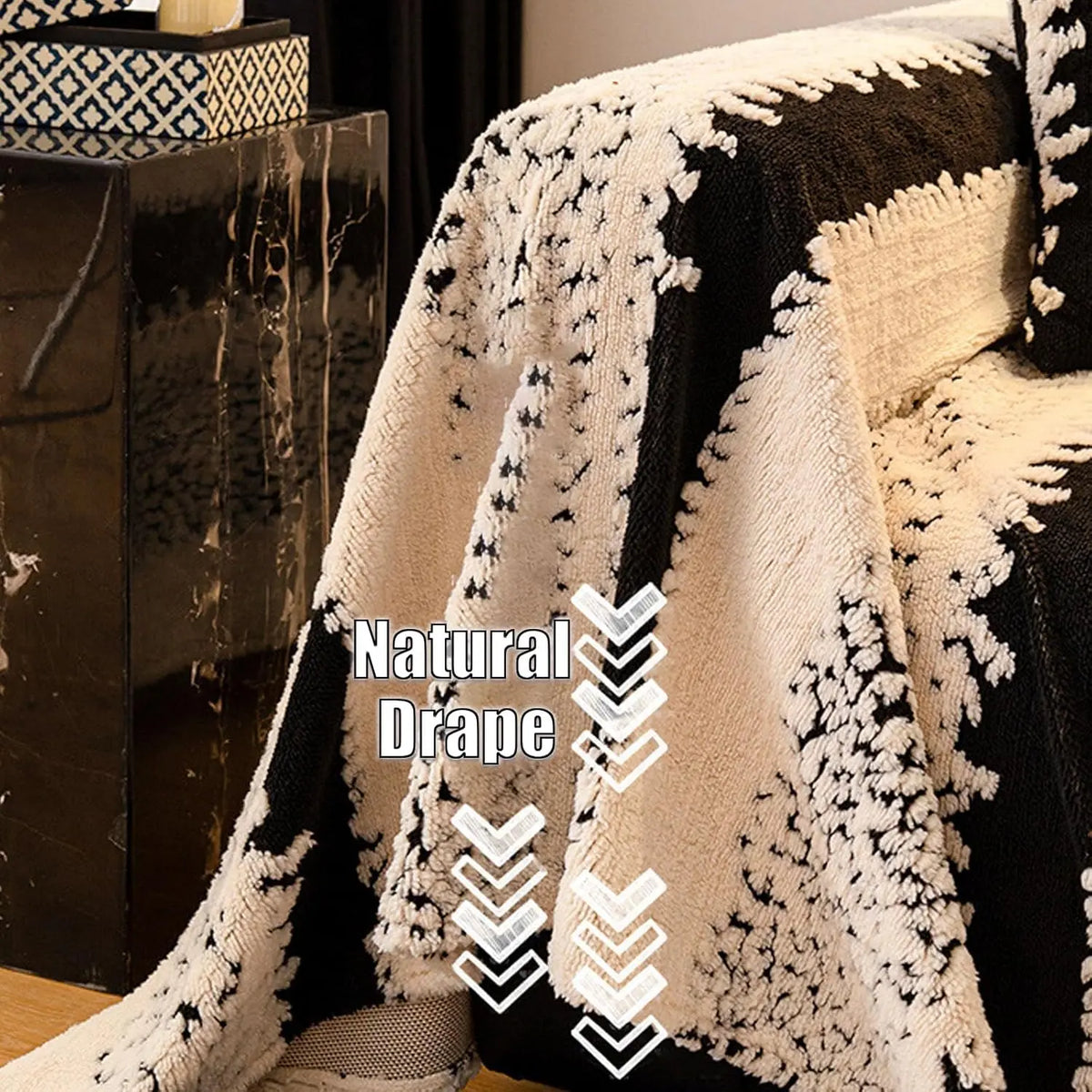 A natural drape of a bohemian striped jacquard sofa throw featuring black and cream patterns.