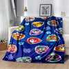 A blue flannel throw blanket featuring various cartoon dog designs and paw prints.
