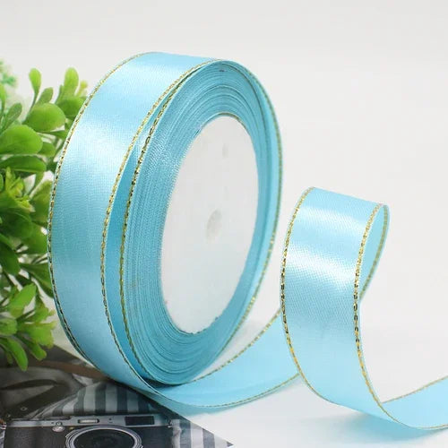Roll of light blue satin ribbon with gold edge for gift wrapping and crafts