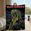 A dark graphic print featuring a menacing skeleton with green hair and yellow clothing, displayed on a blanket.