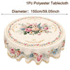 A round polyester tablecloth featuring a vintage floral pattern of pink and cream roses and sunflowers.