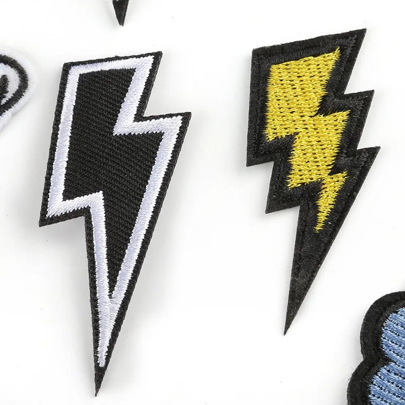 Two black and yellow lightning bolt embroidered patches on white background