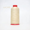 A spool of light beige heavy duty nylon sewing thread with a red cap.