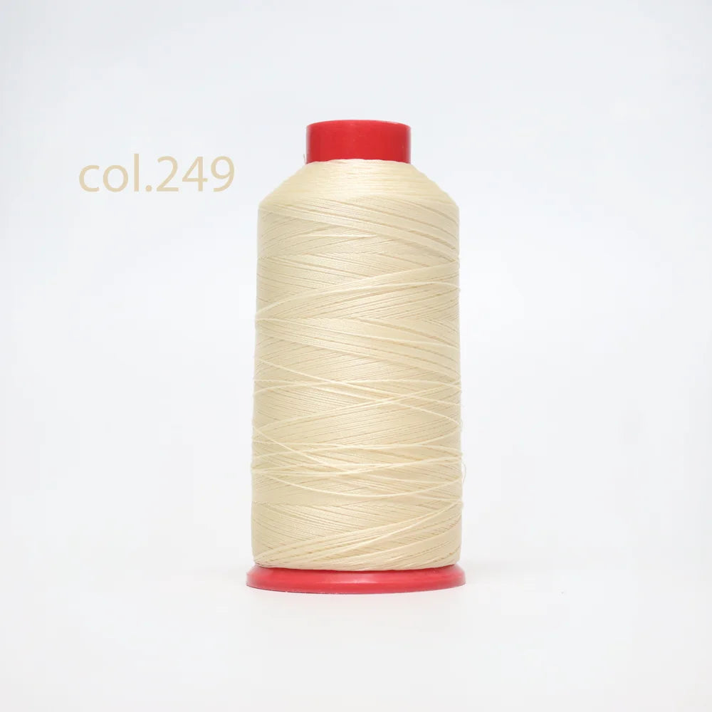 A spool of light beige heavy duty nylon sewing thread with a red cap.