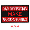 Black embroidered patch with red text that reads BAD DECISIONS MAKE GOOD STORIES