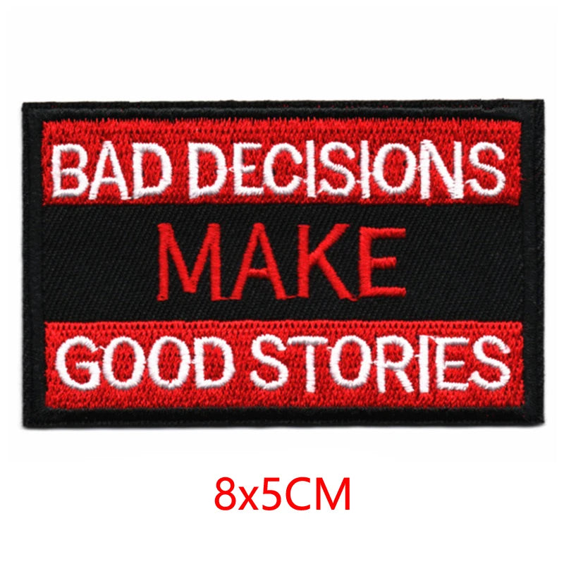 Black embroidered patch with red text that reads BAD DECISIONS MAKE GOOD STORIES