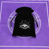 Black velvet tarot cards storage pouch with a white eye symbol design on a purple background