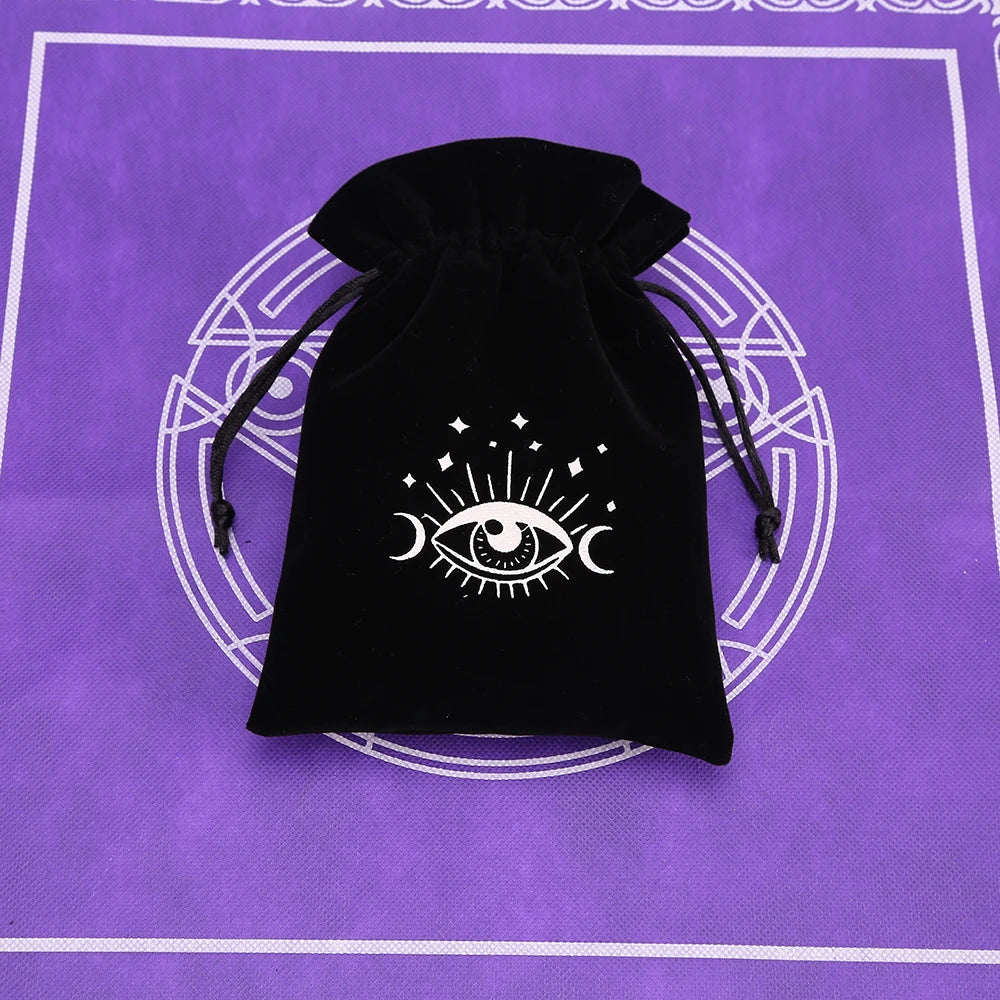 Black velvet tarot cards storage pouch with a white eye symbol design on a purple background