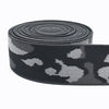 Black and gray camouflage elastic stretch ribbon rolled into a coil