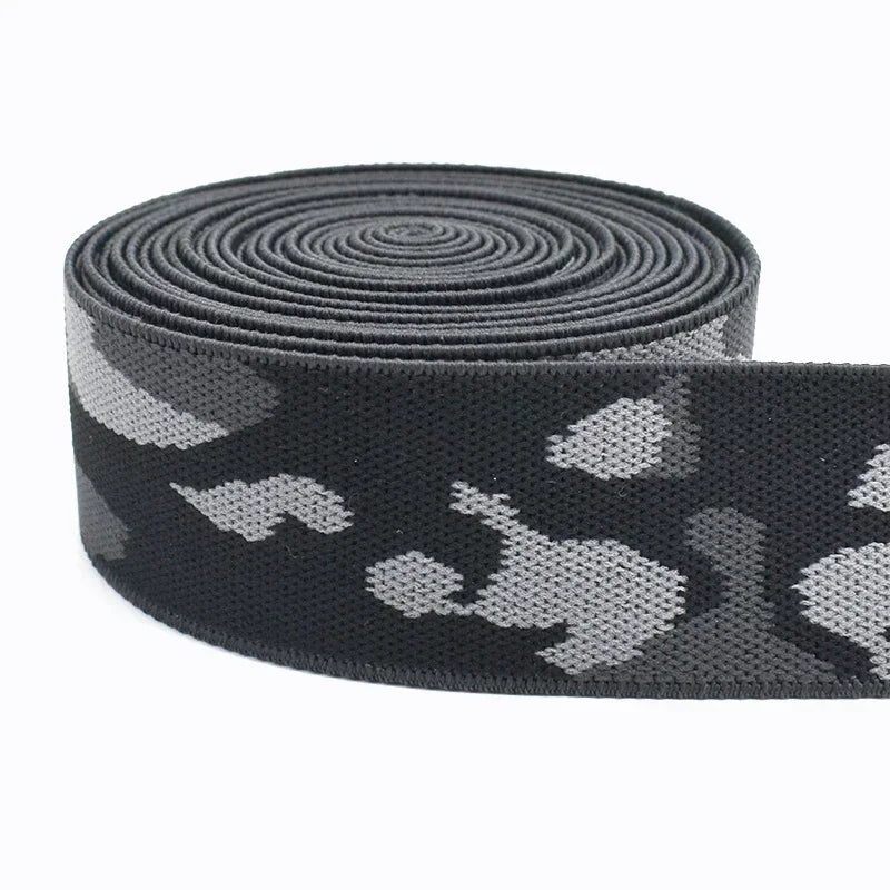 Black and gray camouflage elastic stretch ribbon rolled into a coil