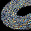 A close-up view of multi-size shiny AB crystal glass beads arranged in a curved line for jewelry making