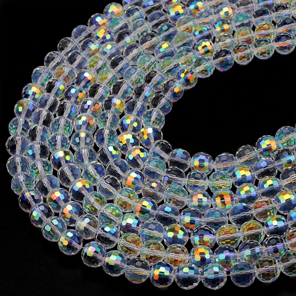 A close-up view of multi-size shiny AB crystal glass beads arranged in a curved line for jewelry making