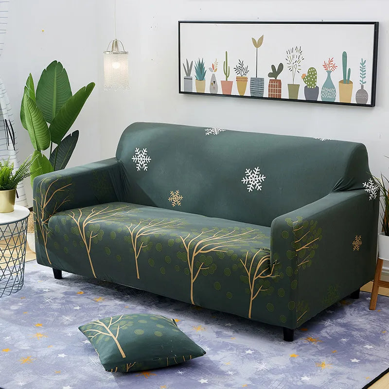 A dark green stretch sofa with a patterned slipcover and a modern floral art print on the wall.