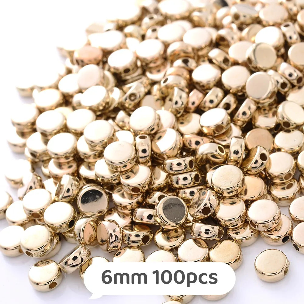 A pile of gold and silver geometric acrylic beads for jewelry making