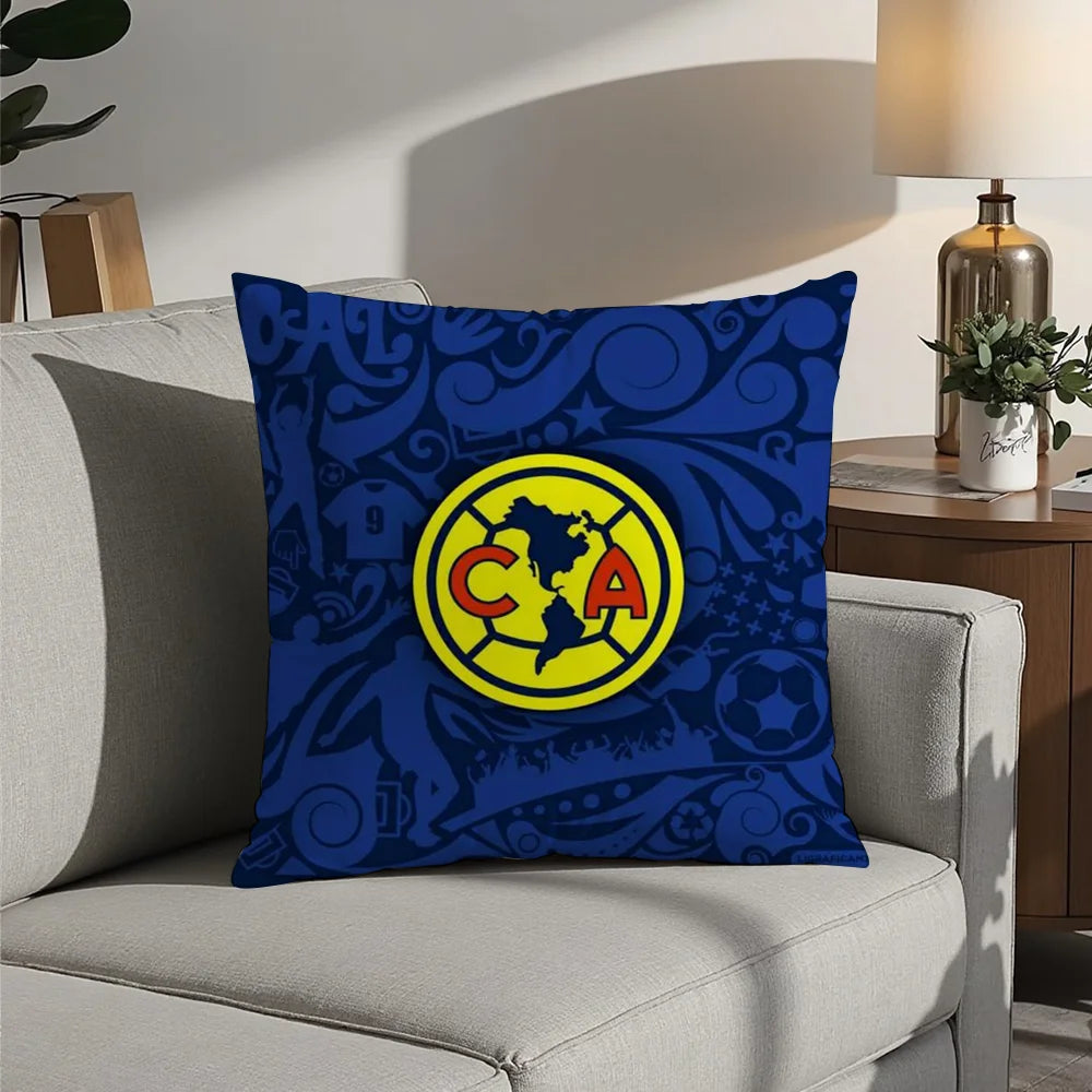 A dark blue decorative pillow featuring a yellow circular logo with the letters CA inside.
