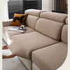 A beige stretchy polar fleece sofa cover is shown on a light-colored sofa with a dark window blind.