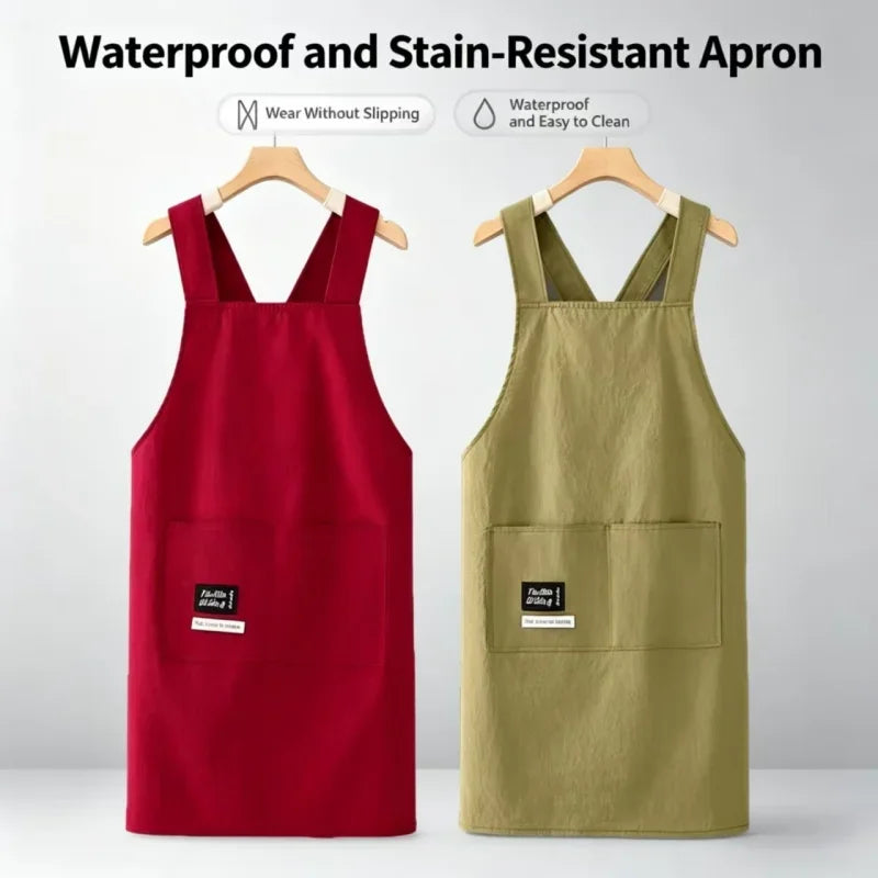 A red and olive green waterproof and stain-resistant apron displayed on a hanger.