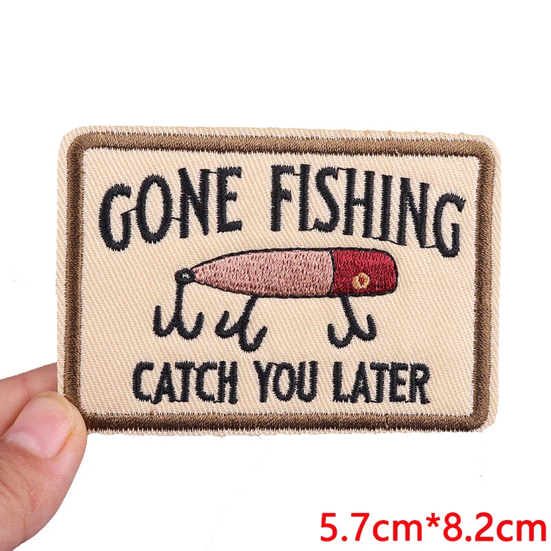 A tan embroidered iron-on patch with black text that reads Gone Fishing Catch You Later