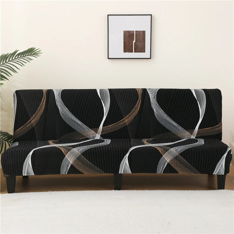 Black and white geometric print spandex slipcovers on a sofa bed with a framed artwork above it.