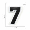 A black number seven patch made of felt is shown against a white background.