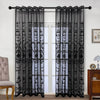 Black sheer curtain with pearl and lace embroidery hanging in a doorway