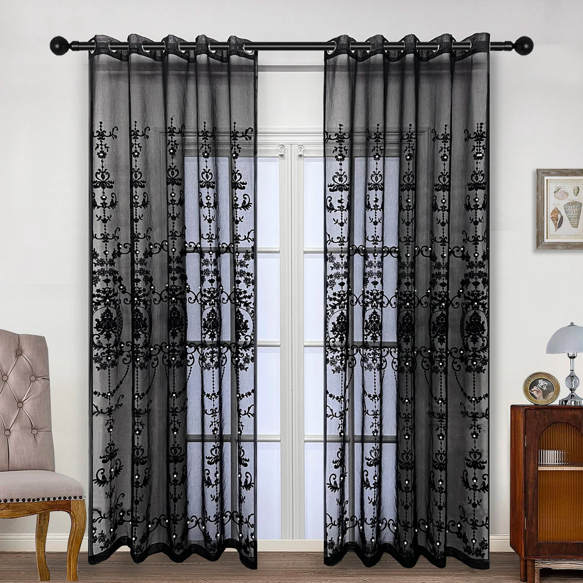 Black sheer curtain with pearl and lace embroidery hanging in a doorway