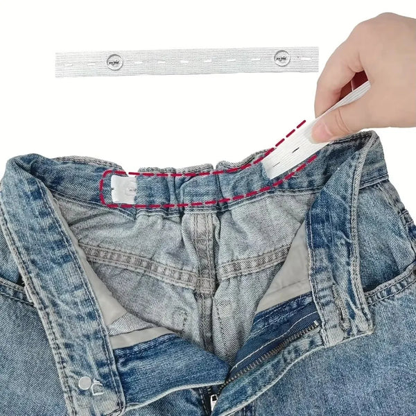 A hand is adjusting an invisible self-adjusting belt tightener on the waistband of blue denim jeans.