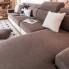 A sectional sofa in brown fabric with light cushions and pillows, featuring a removable jacquard seat cushion cover.