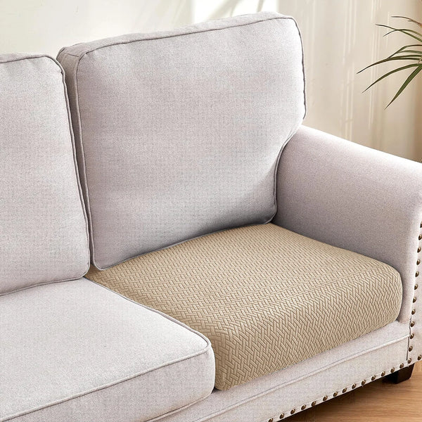 A light gray sofa cushion slipcover with a beige textured insert on a modern sofa.