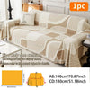 A beige and white striped plush sofa cover displayed on a couch with a decorative cushion.