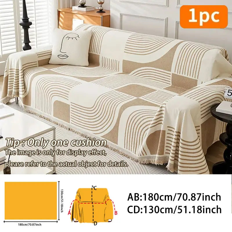 A beige and white striped plush sofa cover displayed on a couch with a decorative cushion.