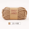 A ball of beige hand-dyed fabric strip yarn labeled Sweet Candy yarns.