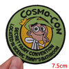 An embroidered patch featuring a cartoon character with a yellow hat and a green background.