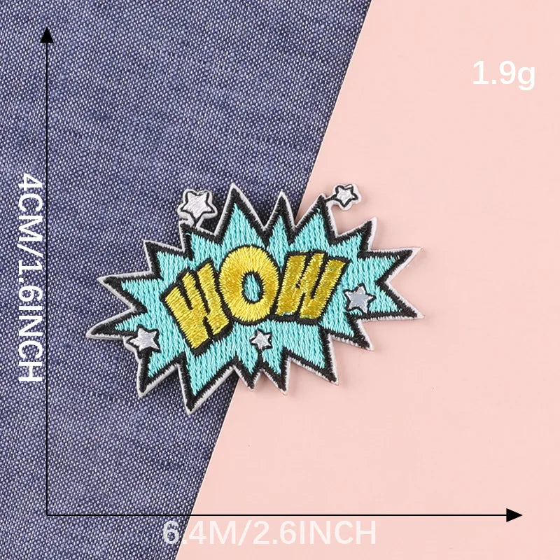 A yellow and blue embroidered patch with the word WOW on a denim fabric background.
