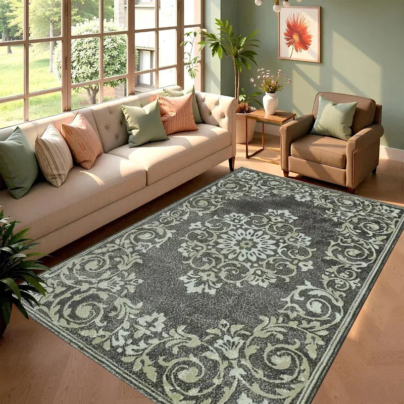 A rectangular gray and cream cowhide print area rug placed in a sunlit living room with a sofa and potted plants.