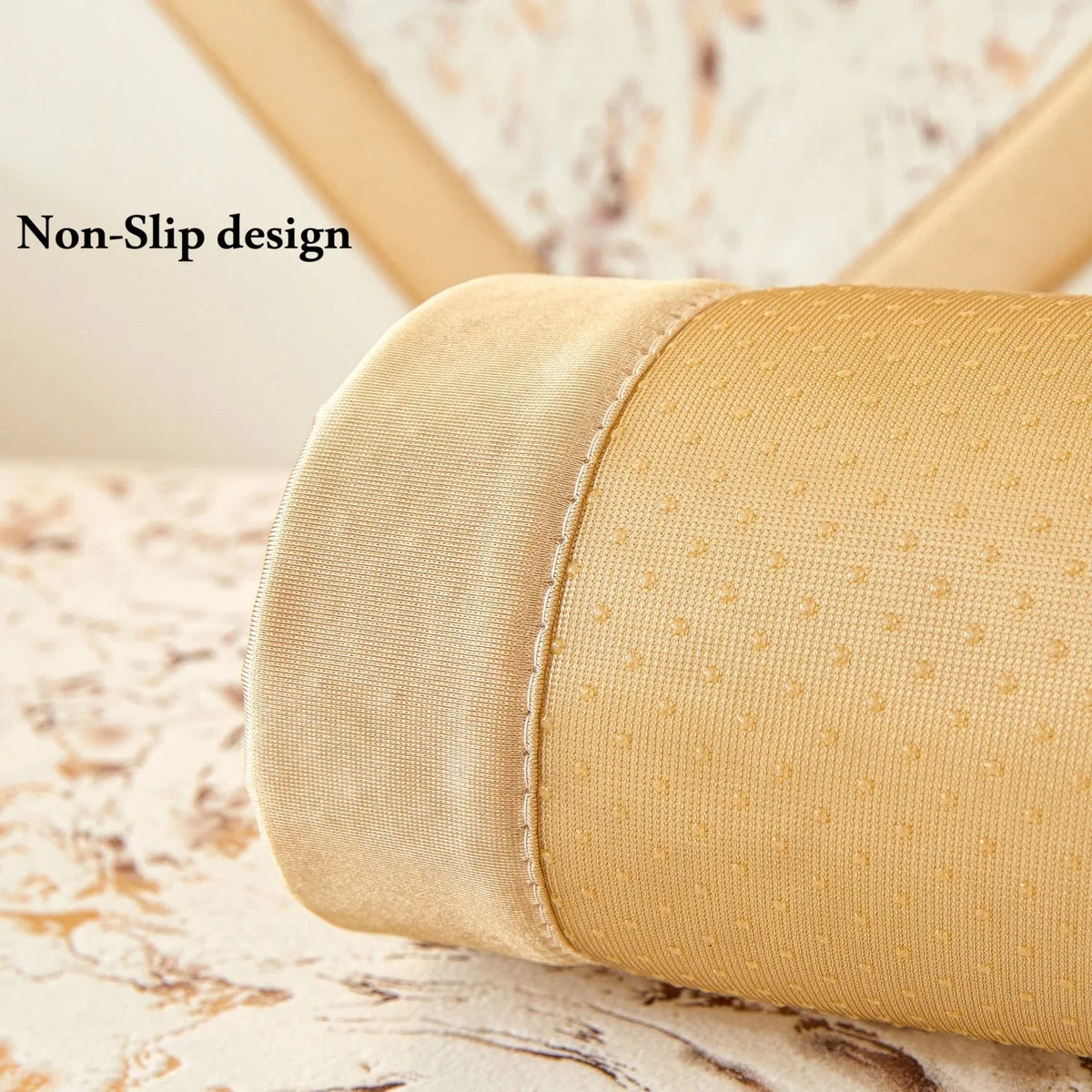 A close-up of a beige velvet sofa cushion cover with a non-slip design texture.