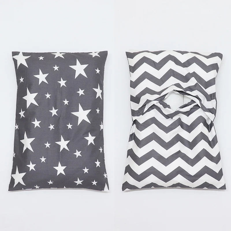 A pair of soft cotton baby pillow covers featuring a gray and white chevron pattern with stars.