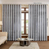 Gray vintage floral blackout curtains hanging in a window frame.