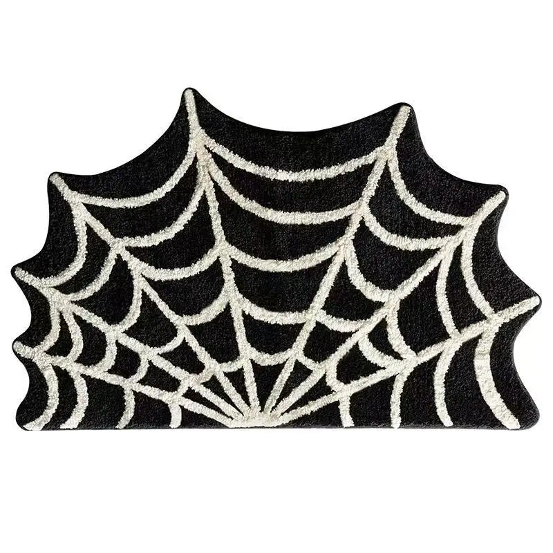 A black decorative non-slip foot mat featuring a white spiderweb pattern.
