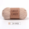 A skein of beige sweet candy yarn labeled with Japanese text, ready for crochet or knitting.